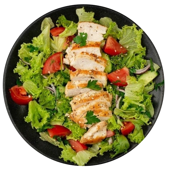 Grilled chicken breast served on a fresh green salad with tomatoes and lettuce – a healthy and delicious option for home meals.
